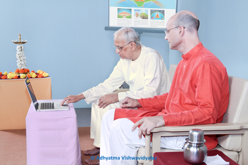 His Holiness Dr Athavale (left) launches the website for the University of Spirituality. He is joined on stage by His Holiness Cyriaque Vallee (right).